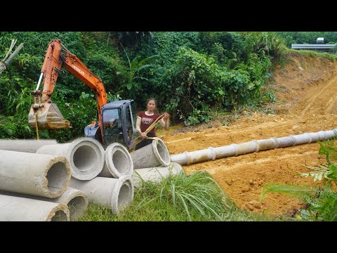 Excavator and work on building a large pond. Installing concrete pipes - Building a new life
