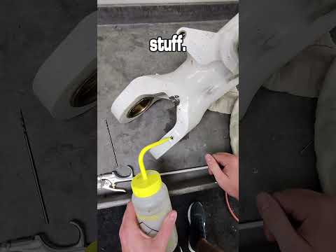 Unclogging a grease port.