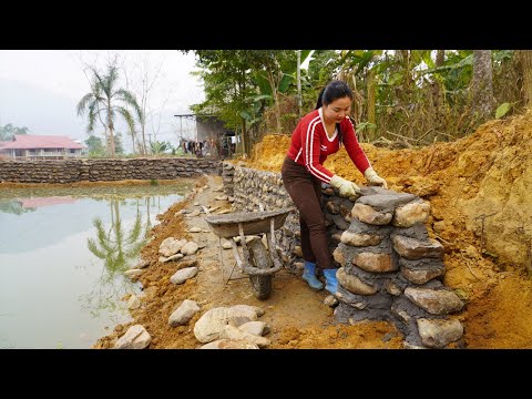 Dung helped the village man build wall around the fish pond using billions of stones - Hard work