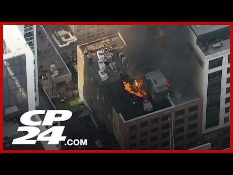 Chopper video captures a big explosion from a rooftop fire in downtown Toronto