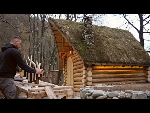 House made of logs. Lighting with a water wheel and DIY lamps