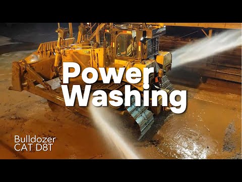 Washing heavy equipment with super pressure. CAT D8T bulldozer