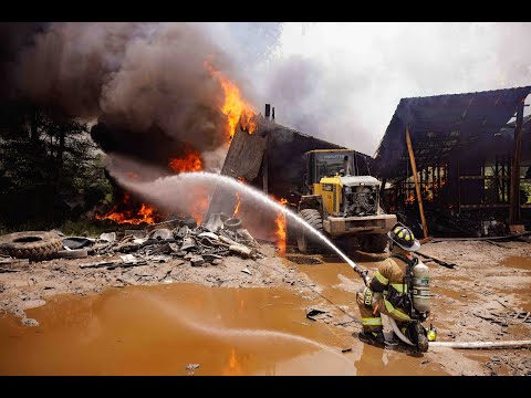 Jacksonville Fire Rescue Department fights vehicle fire that catches commercial structure