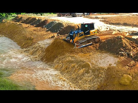 Perfectly Machine Bulldozer pushing soil landfilling up filling into the big pond & clearing mud