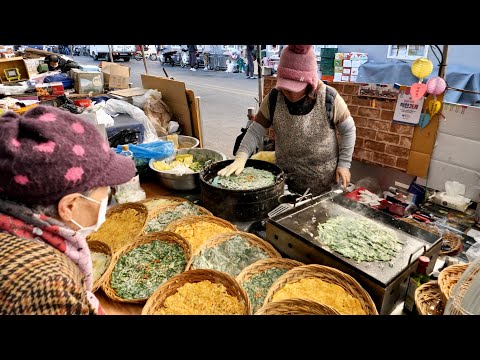 Korean pancakes (buchimgae) made by pounding with bare hands Korean street food