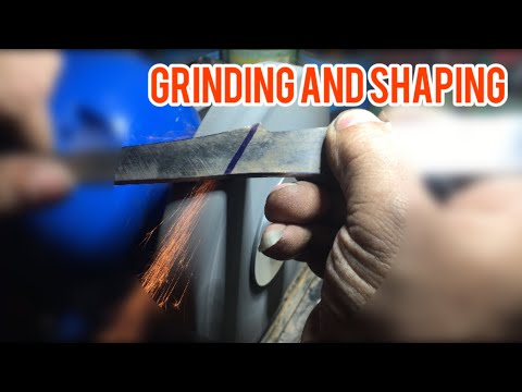 Knife making. Grinding line with table stone. Sanding.