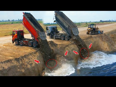 Be careful, the bulldozers incredible skills to push rocks into the deep lake with a rock dump truck