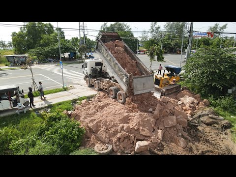 Large Filling Stones Project Using Heavy And Big Team Bulldozers With Dump Trucks Operated