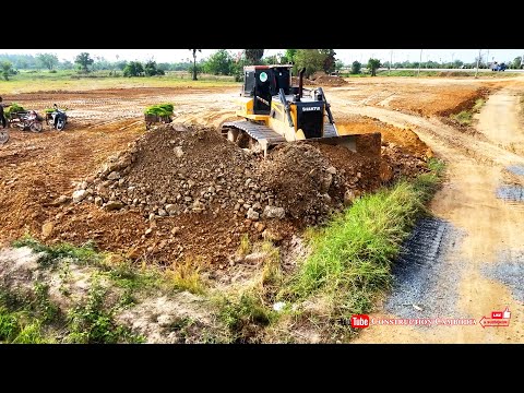 Bulldozers Push Massive Loads While Dump Trucks Transport Soil