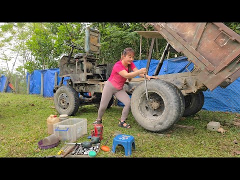 The girl repairs and maintains farm cars for her neighbor.