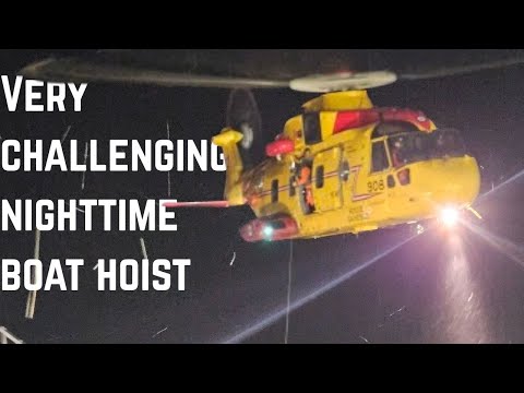RCAF Cormorant helicopter medevac from a cargo ship at night.