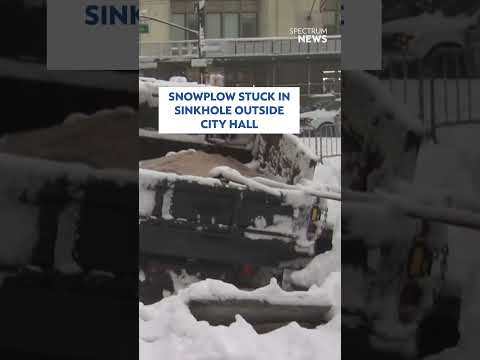 Snowplow stuck in sinkhole outside City Hall