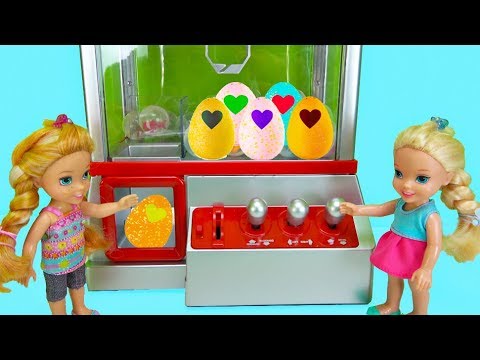 Elsa and Anna toddlers win Hatchimals from the claw machine