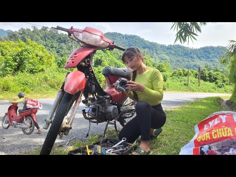 Girl fixes broken motorbike engine on the roadside