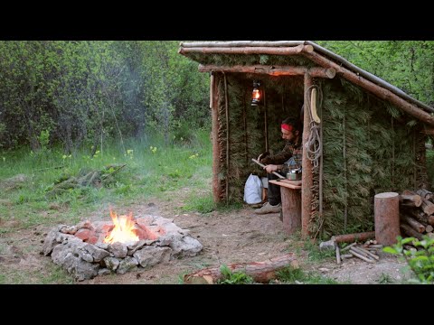 Building a Summer Shelter of Pine Branches. Stone Outdoor Fire Pit . Harvest Birch juice