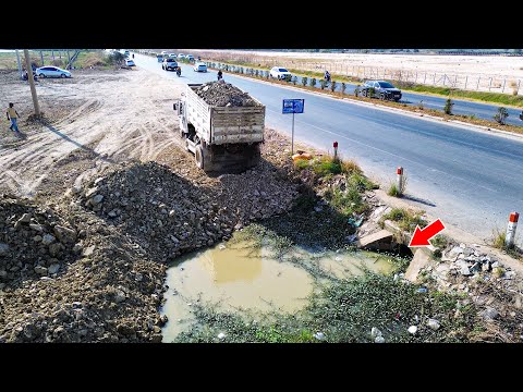 Awesome bulldozer skill pushing soil and stone filling land with dump trucks