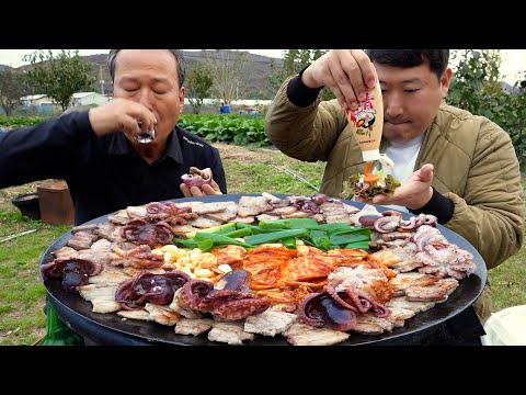 Grilling freshly caught webfoot octopus with pork belly on a cauldron lid - Mukbang eating show