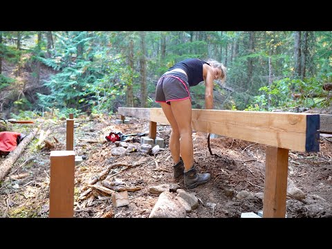 Just a girl, building her fort in the woods.