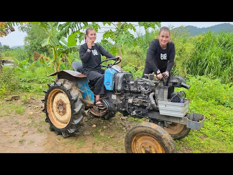 The girl repaired and restored the old tractor was broken for the neighbor.