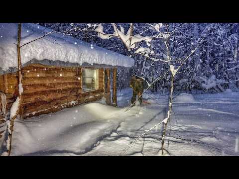 I'm burying a log cabin with snow to keep it warm inside.