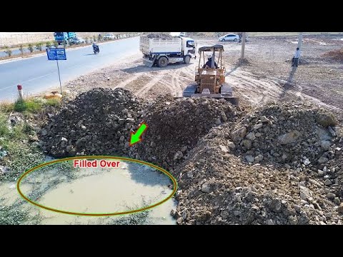 Full landfill processing, awesome work bulldozer operator Komatsu D31P & excellent dump trucks