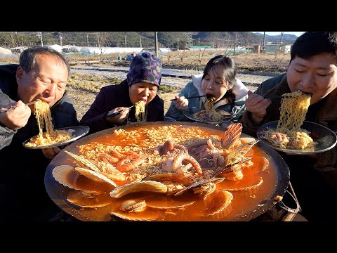 Spicy seafood instant noodles on a cauldron lid - Mukbang eating show