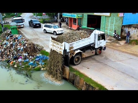 Amazing job the big pond filling by dump truck unload and bulldozer KOMAT'SU push the stone