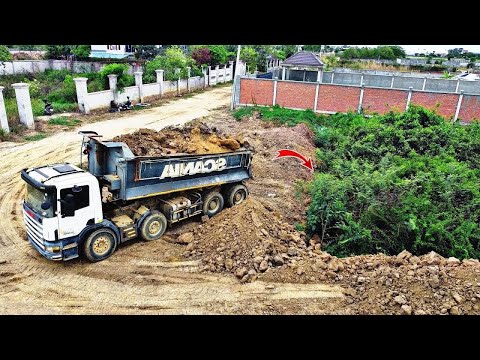 Powerful Komatsu D58E Bulldozer Pushes soils and fill in forest with 25ton dump truck pouring soil