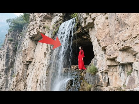 A mysterious waterfall cave was found on the steep cliff in Shanxi Province  where a red-dressed be