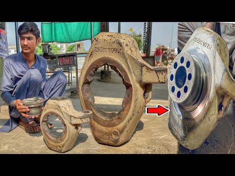 The broken pieces of the excavator's front wheel hub were assembled by a mechanic