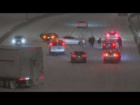 Multiple cars still stopped along eastbound Woodall Rodgers Freeway in Downtown Dallas
