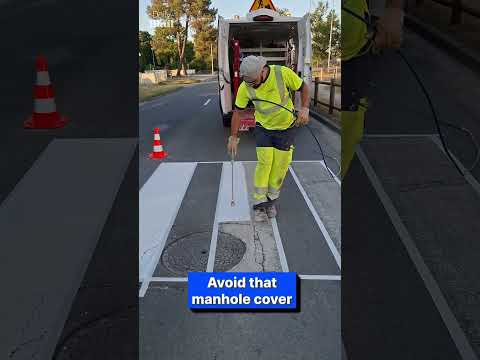 Worker perfectly paints road