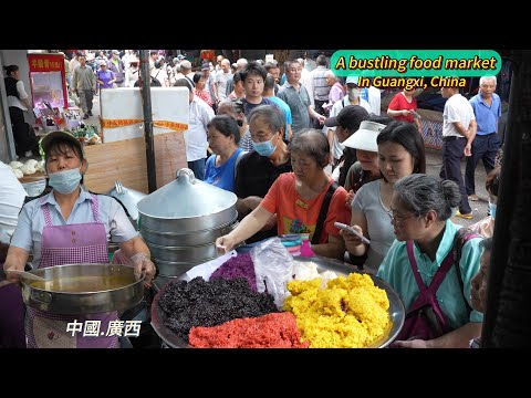 Colorful street food at a busy market in Guangxi, China, as citizens rush to buy rice noodles