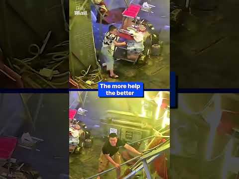 Restaurant owner holds down tent during storm