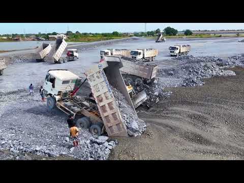 Launch New Projects and Up Rock by pushing dump trucks with wheel loaders and unloading 25-ton truck