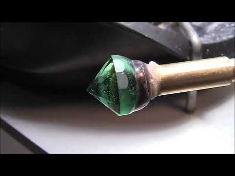 Faceting a helenite gemstone.
