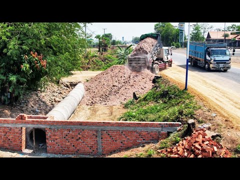 Dropping soil bury drainage system next to the road. Drivers passing by must be very careful.