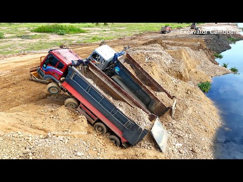 Dump truck that collapsed due to filling soil into a lake. Rescued by a skilled  2 bulldozer driver