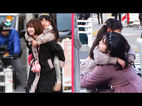 A girl with an injured leg cannot cross the street, what is the reaction?