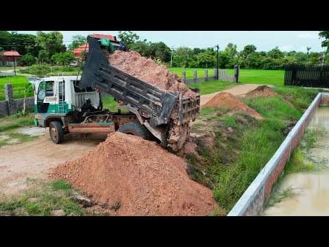 Dropping soil to clean weeds around the pond. and buried soil to protect the fence foundation