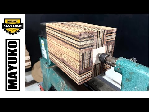 A STRIPED VASE WITH A WHITE BLOCK IN THE CENTER, woodturning