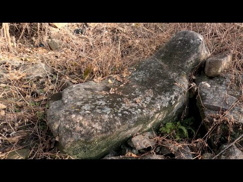 There is a primitive stone age grindstone in the yard of an empty house!