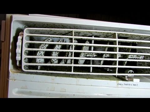 Cleaning mold out of a window AC unit.