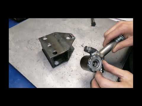 Backlash-free towing hitch for a walk-behind tractor on bearings.