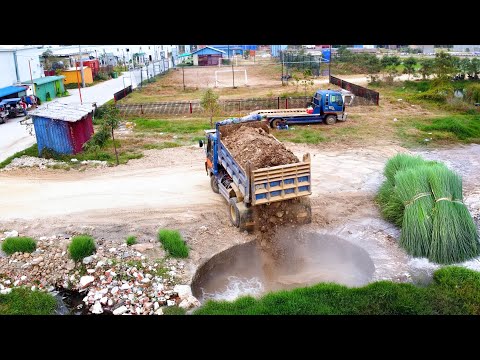The deep hole filling by soil truck unload and bulldozer pushing