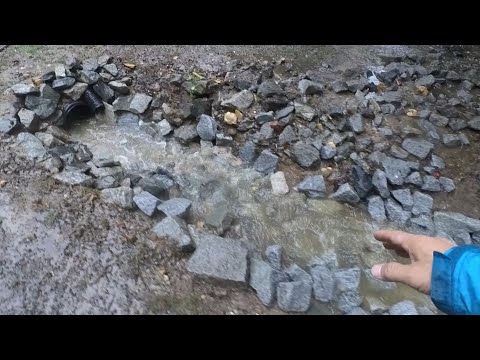 Mucking out a drainage ditch to solve driveway flooding issues