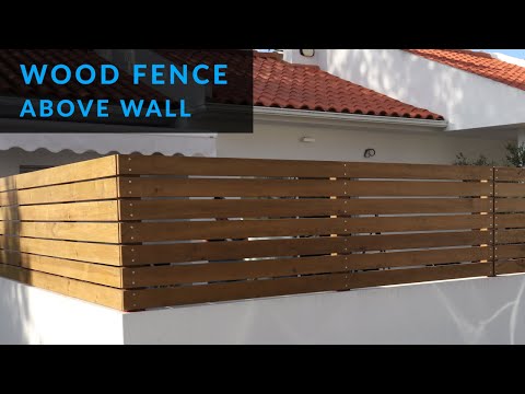How to Install a Wood Fence Above a Wall
