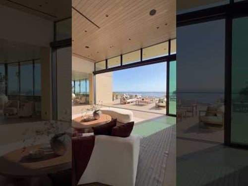 From the living room to the deck, the ocean never leaves the frame.