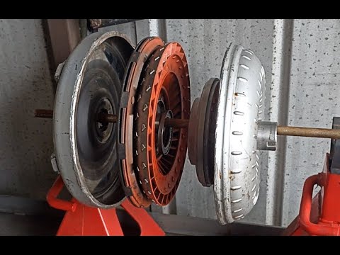 How does the torque converter work in automatic or hydraulic transmissions?