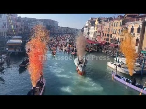Dozens of boats bearing costumed participants sail along Venice's Grand Canal in Carnival parade